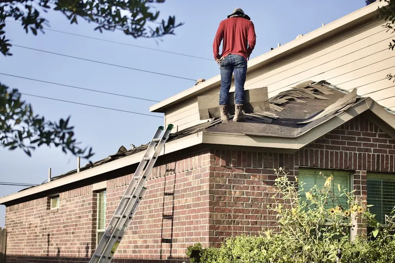 Professional roofer working on a residential roof in Watertown West End